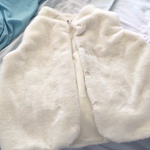 A white vest buttons hardly worn